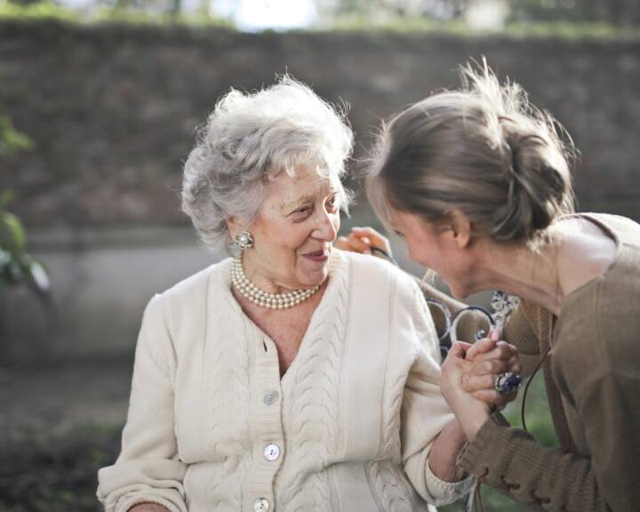 Care professional supporting an adult with daily living at home